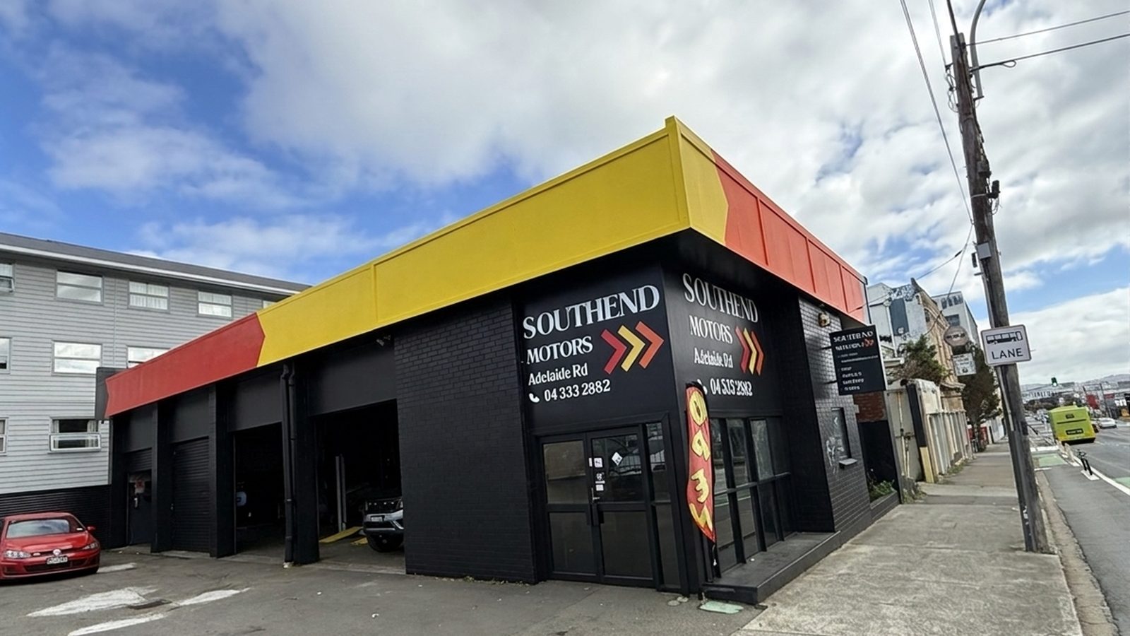 South End Motors Newtown, a new black shopfront on Adelaide Road with a red and yellow awning